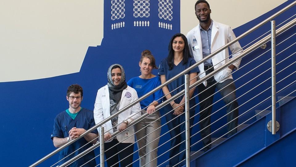 A group of health students standing on the staircase in Innovation Hall